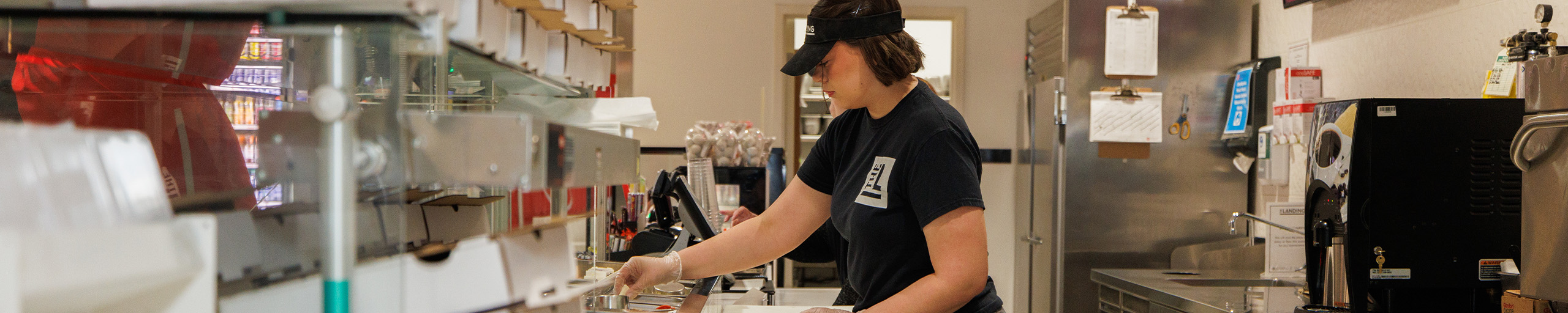 Dining employee cleans a table.